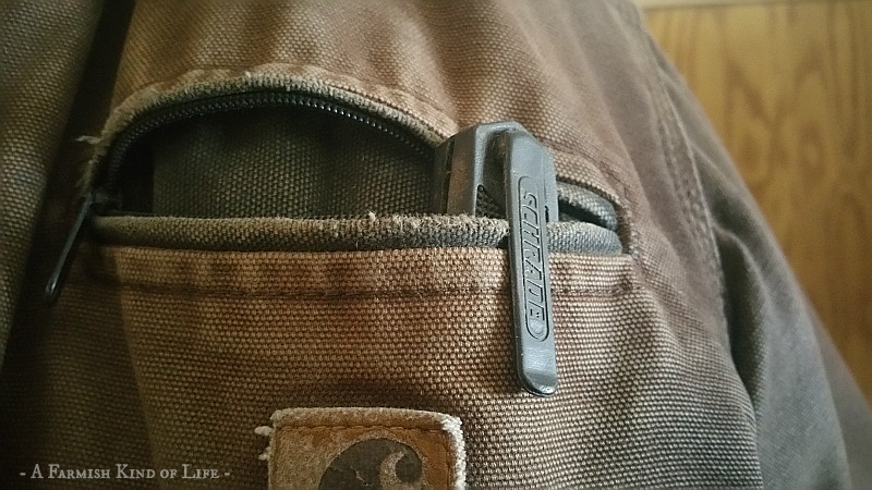 A pocket knife sticking out of the pocket of my barn coat. It's one of the things every homesteader needs. 