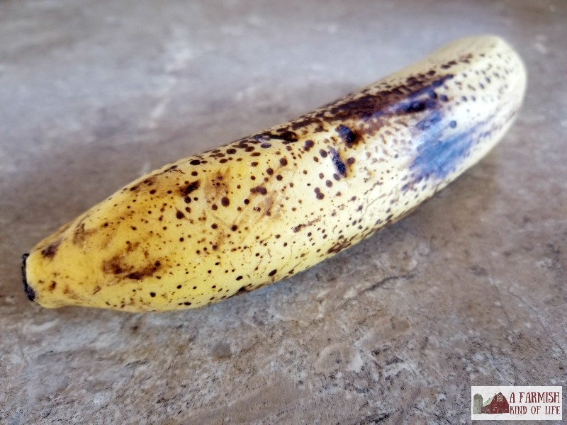 A ripe banana sitting on a counter.