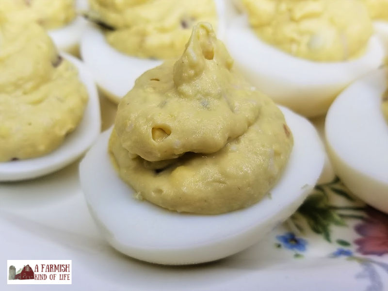 Cheesy Bacon Deviled Eggs is a twist on the usual deviled eggs recipe, adding two of the best things in life: cheese and bacon!